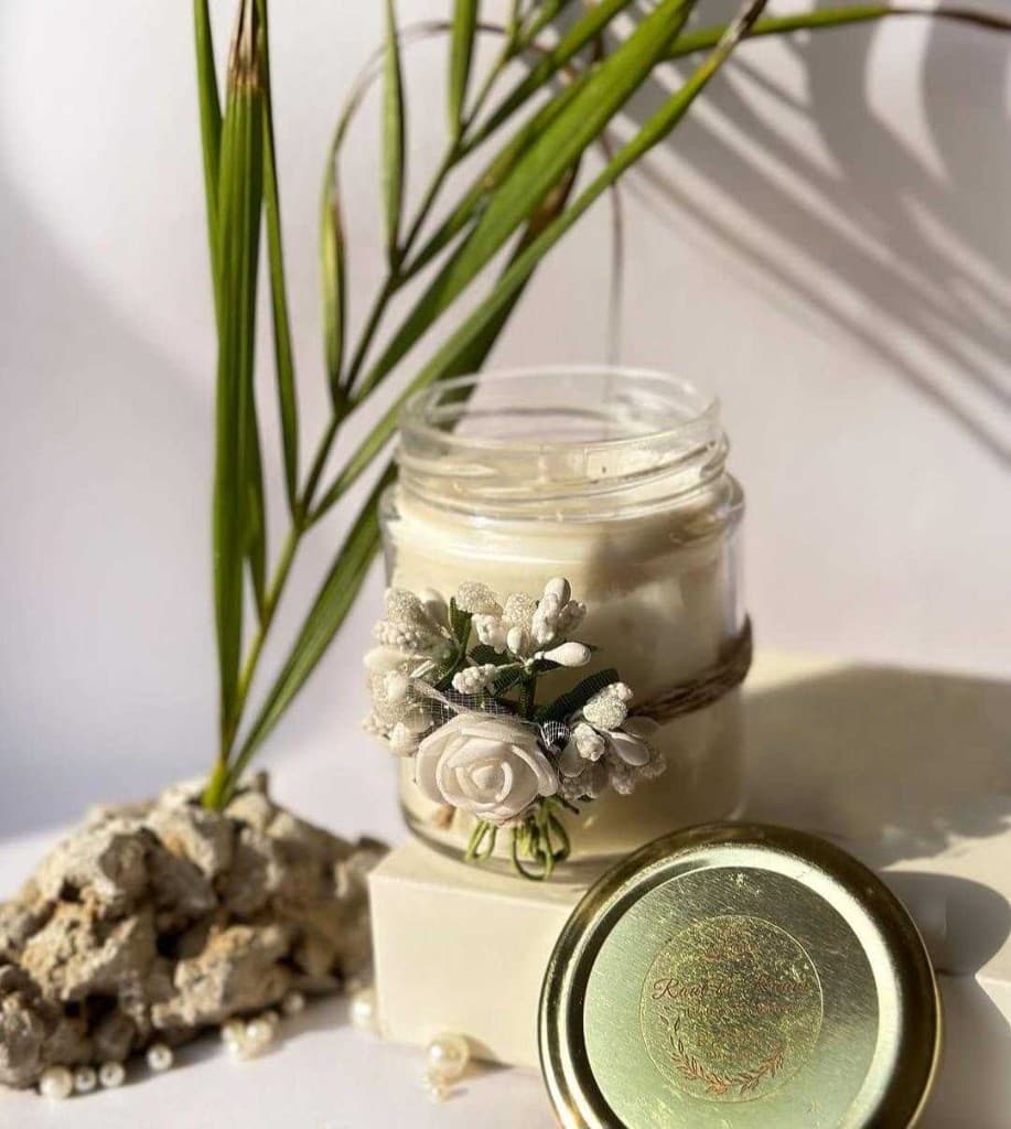 Handmade candle with floral accents in soft natural light